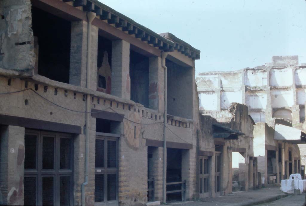 Decumanus Maximus, Herculaneum, 4th December 1971. Entrance doorways to V.17/16/15, Casa del Bicentenario (narrower taller doorway. left of centre), and 14/13. 
Looking south-west towards south side of Decumanus Maximus.
Photo courtesy of Rick Bauer, from Dr George Fay’s slides collection.
om Dr George Fay’s slides collection.